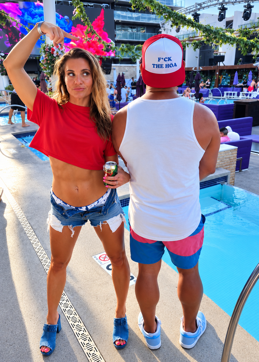 Customer pointing to a red F*CK THE HOA hat at a poolside gathering