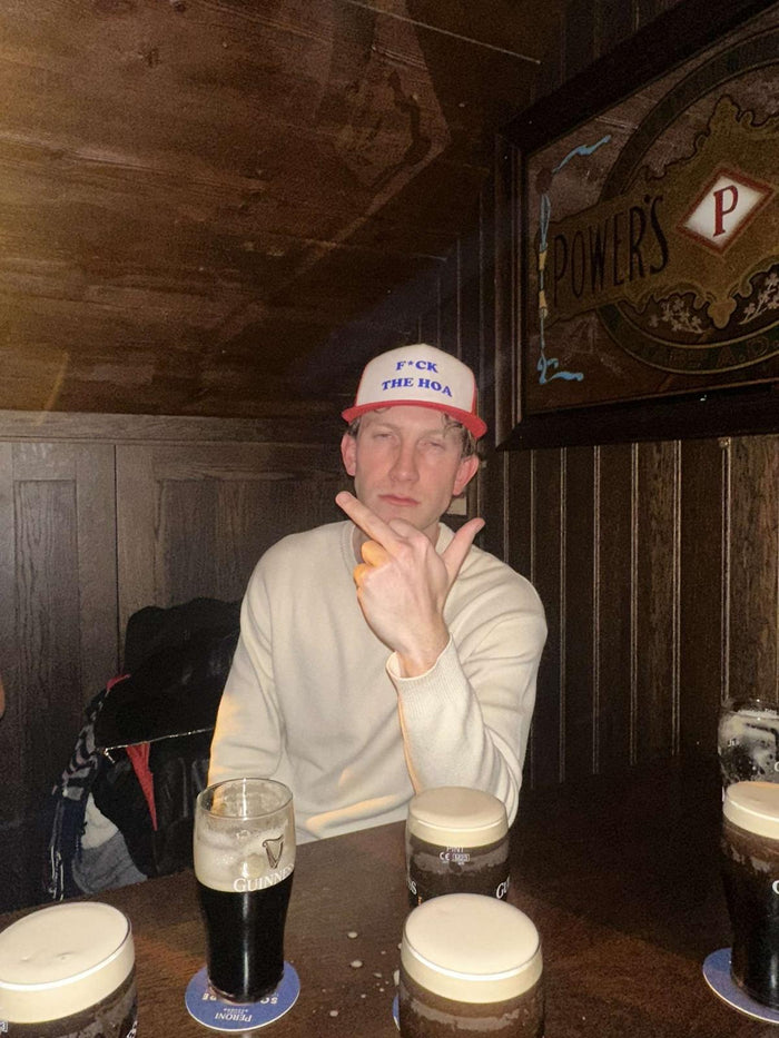 Customer in a red hat seated at a pub table